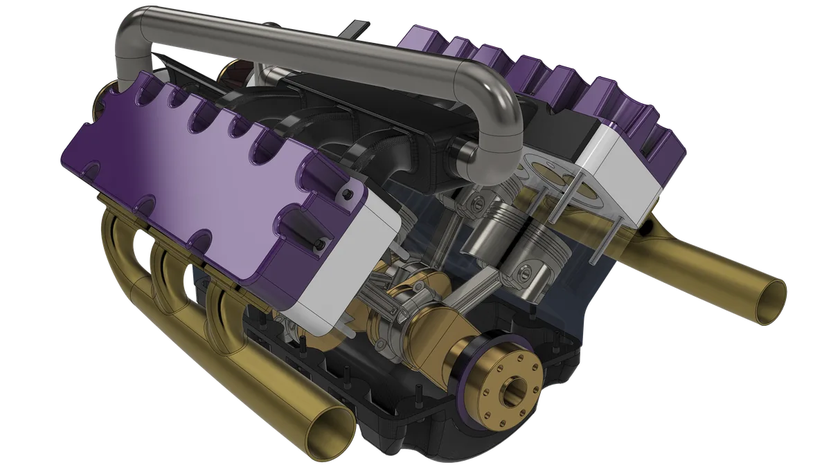 The V6 engine from the rear three-quarter, with brass 3-into-1 headers on both banks and the block shown see-through