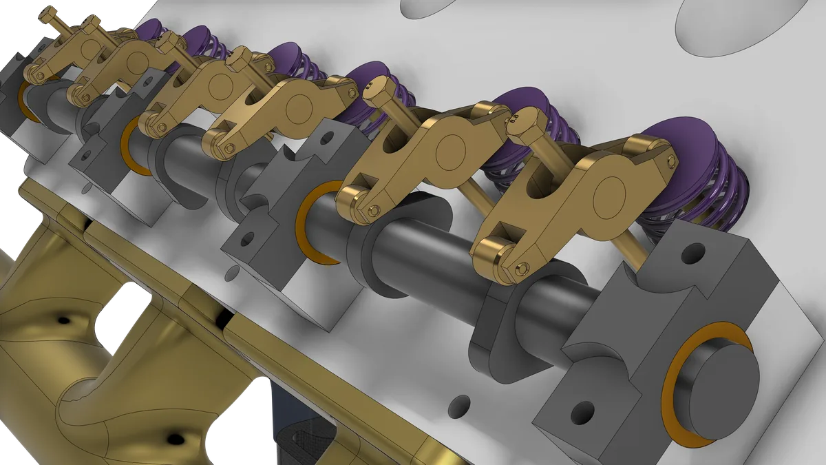 The camshaft in its bearing blocks along the head, with a brass roller rocker for each valve and purple valve springs